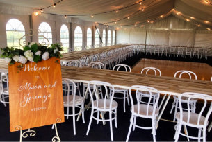 Rustic tables and chairs at Living Legends marquee wedding