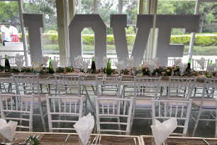 Giant Love Letters and rustic tables and chairs for an anniversary lunch 
