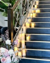 LED vase and candle package lining the stairs at James Said