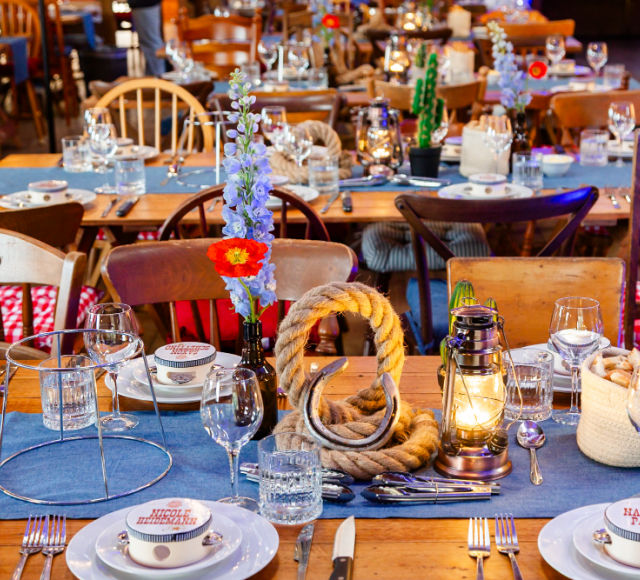 Wooden dining tables setup for a Country & Western themed gala