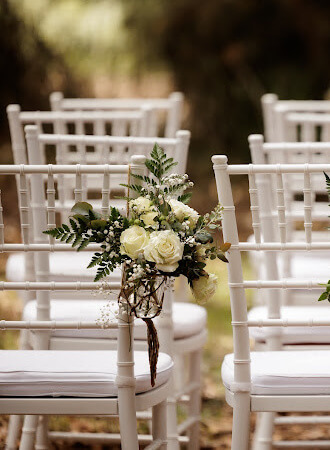 White Tiffany Chairs setup for a wedding ceremony