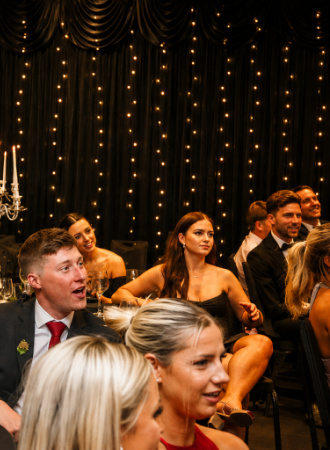 Guests laughing at a gala dinner