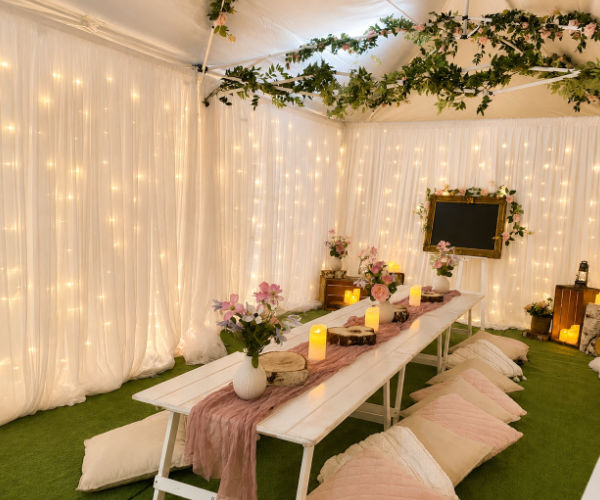 An enchanted marquee filled with fairy-lights for a kids fairy party