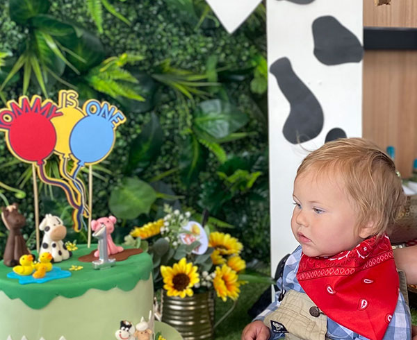 One year old sitting in front of a giant number 1