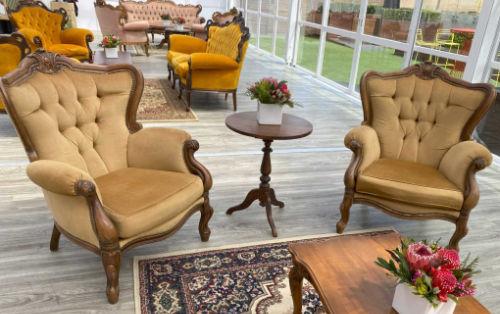 Image shows vintage furniture setup at a corporate event