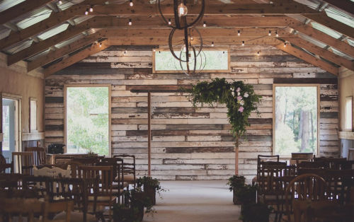 Photo shows a rustic wedding ceremony setup at The Log Cabin Ranch