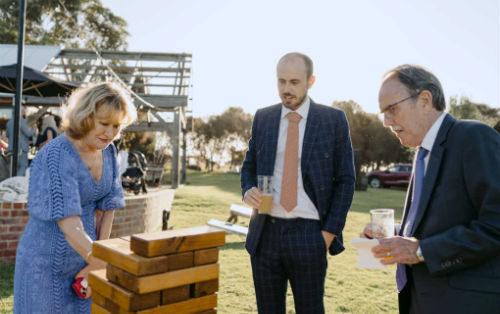 Photo shows wedding guests playing Giant Jenga at Phillip Island Winery wedding
